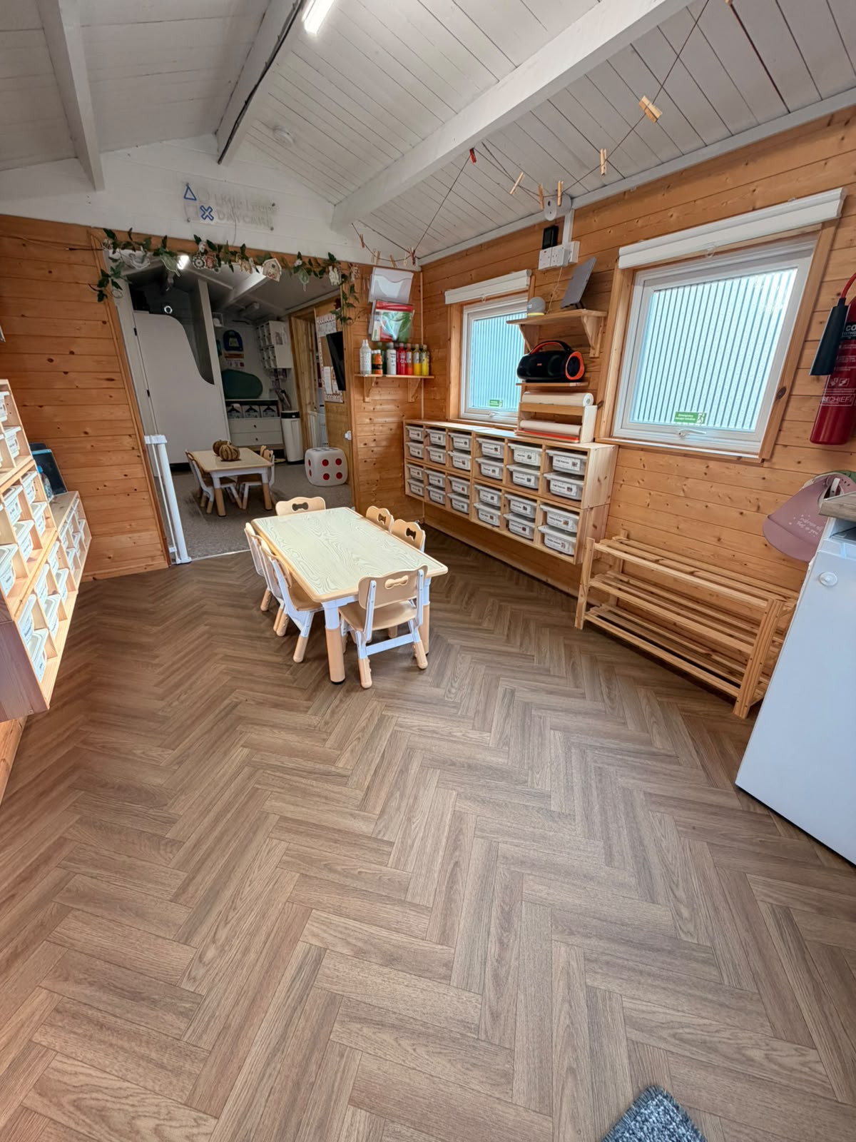 A Basildon indoor activity room with child-height tables and storage for learning resources