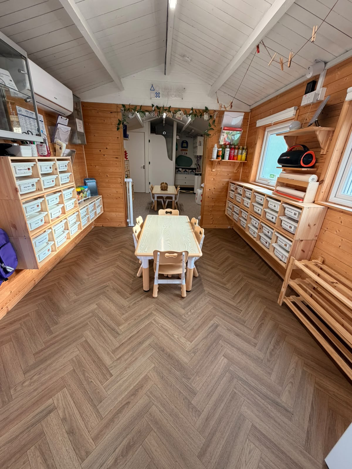 A view through the Basildon indoor room showing organised storage and table activities