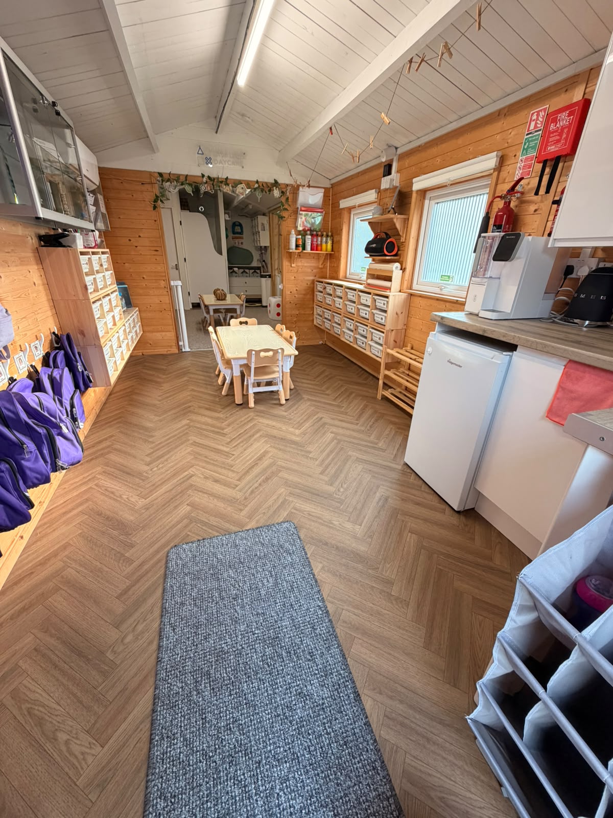 A Basildon indoor room with child-height tables, cubbies and practical daily resources