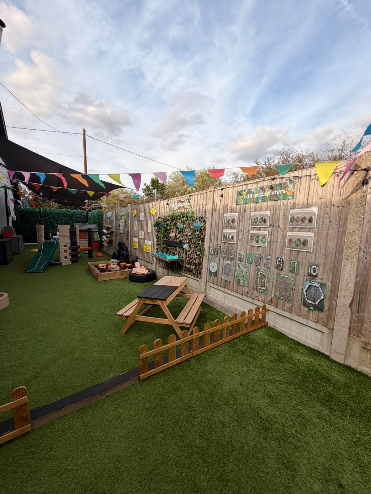 A long view through the Basildon garden showing outdoor activity zones and bunting